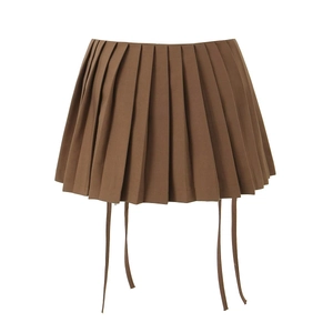 Detail of brown pleated mini skirt with hanging ties and high-waist design