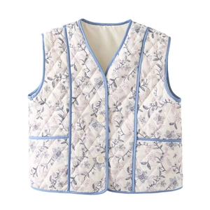 Detailed view of quilted cotton vest with blue floral print and symmetrical pockets
