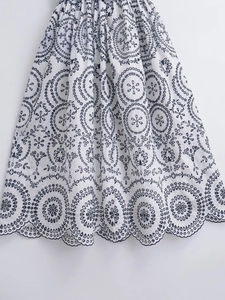 Women's V-neck dress with white base and dark blue floral embroidery and scalloped hem