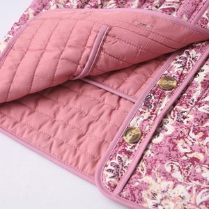 Detail of floral quilted cotton jacket featuring vintage prints and marble pattern buttons