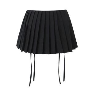 Detail of high-waisted black pleated skirt featuring adjustable hanging ribbons