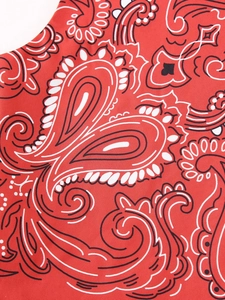 Macro detail of red paisley cotton fabric with classic bohemian bandana print texture