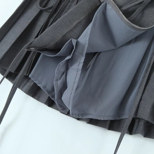 Detail of grey pleated skirt showing safety shorts lining and side zipper closure