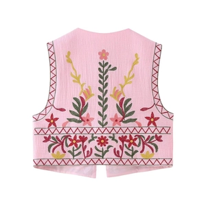 Detailed back view of pink Y2K vest featuring intricate floral embroidery on textured fabric