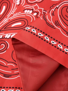 Detailed close-up of the red paisley printed fabric showing twill texture and inner lining