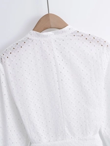 Detailed view of white eyelet embroidery and stand collar on French vintage cotton dress