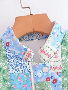 Close-up of quilted floral patchwork jacket featuring turnover collar and buttons