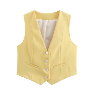 Detail of pale yellow V-neck waistcoat featuring white buttons and functional inner lining