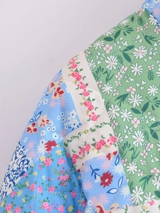 Detail of floral patchwork pattern and quilted diamond stitching on women's jacket