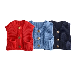 Detailed view of V-neck knitted vests in red, blue, and navy showing texture and buttons