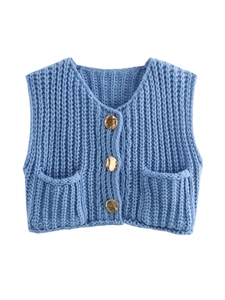 Detailed view of blue chunky knit vest featuring gold textured buttons and twin pockets