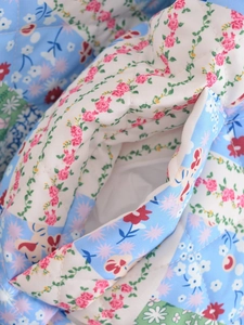 Close-up of quilted floral fabric texture with diamond stitching for autumn cotton jackets