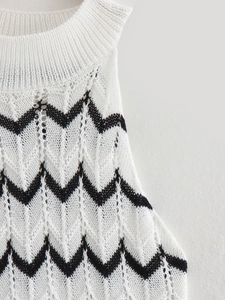 Close-up of white knitted fabric with black wavy stripes and hollow point textures