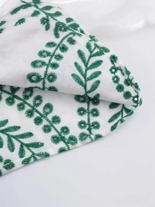 Sexy backless mini dress with green leaf embroidery and delicate cutout details