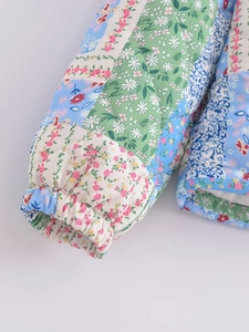 Detailed close-up of quilted floral jacket cuffs with elastic ends and fine diamond stitching