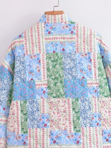 Detailed macro view showing the diamond quilting and floral patchwork of the jacket