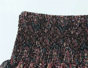 Detail of smocked elastic waistband featuring bohemian honeycomb print pattern