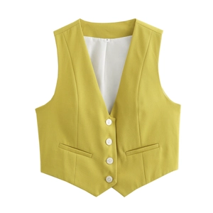 Detail of lime yellow V-neck vest showing white buttons and decorative welt pockets