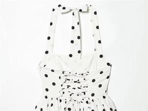 Detail of polka dot halter dress back with lace-up tie and elastic shirred design