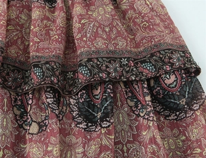 Close-up of pink paisley print chiffon skirt with layered ruffles and textured fabric