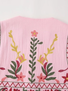Detailed close-up of floral embroidery on pink crinkle cotton vest fabric