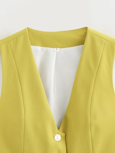 Close-up of yellow suit vest neckline with white button and S size label detail