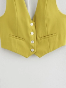 Detail of yellow V-neck suit vest showing shell buttons and premium fabric texture