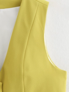Detail view of mustard yellow vest blazer with notched lapels and fine twill texture