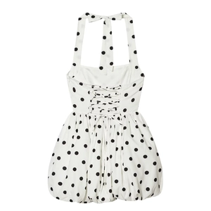 Polka dot halter neck dress in white and black with lace-up back and bubble hemline