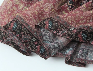 Detail of bohemian honeycomb and paisley print hem on a vintage pink fashion skirt