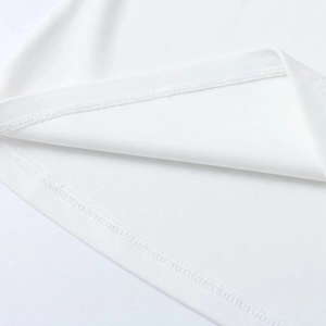 Detailed macro view of the professional double-needle hem stitching on white knit fabric