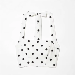 White halter top with black polka dots featuring a stylish neck bow tie detail