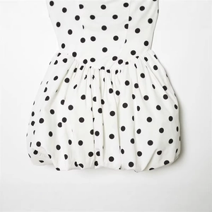 Chic white polka dot halter dress featuring high waist design and pleated puff skirt