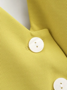 Detailed macro view of vibrant yellow-green twill fabric with two white resin buttons