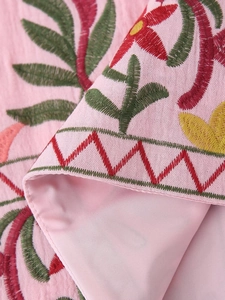 Close-up of pink Y2K vest featuring intricate floral embroidery and neat inner lining