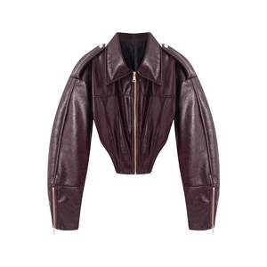 Detail view of burgundy faux leather jacket featuring metal zippers and elastic waist
