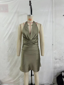 Detail of olive green satin halter neck mini dress with side ruching and draped neckline
