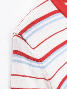 Detail of red and blue stripes on knitted fabric with ribbed crew neck stitching