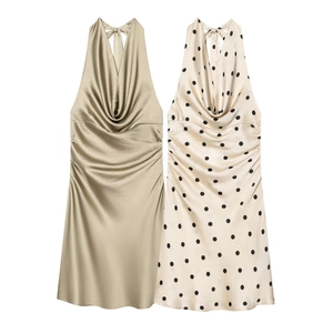 Detail of satin halter neck dresses with draped necklines in gold and polka dot patterns