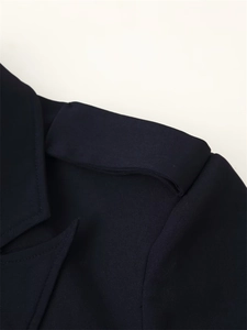 Detail of elegant navy blazer shoulder with epaulet and precise stitching on twill fabric