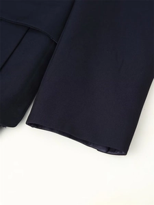 Detail of navy blue blazer sleeve and hem featuring premium smooth fabric and fine stitching