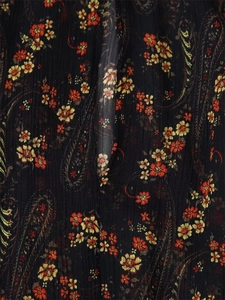 Close-up of paisley floral print on black chiffon fabric with crinkle texture