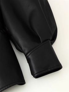 Detail of double-stitched cuff on black faux leather jacket with lychee texture