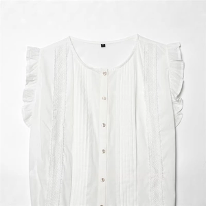 Women's white sleeveless cotton shirt featuring ruffled shoulders and lace hollow details