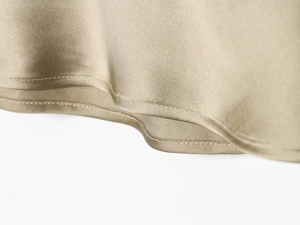 Detailed close-up showing the premium champagne satin fabric and precise double-stitch hemline