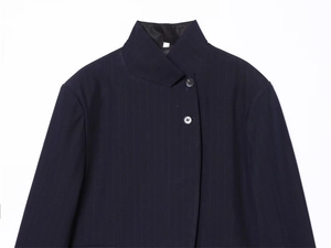 Detail of high neck dark blue pinstripe blazer with black resin buttons in a modern cut