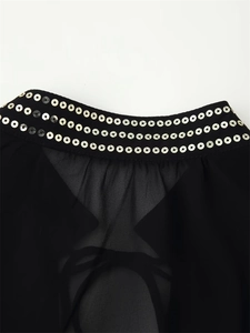 Close-up of metallic sequins and sheer chiffon fabric on a black women shirt neckline