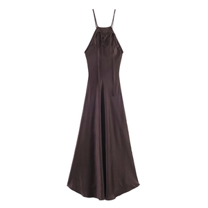 Detail of elegant chocolate satin halter dress with a delicate front bow and silky texture