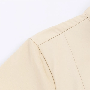 Close-up of double stitching detail and diagonal twill texture on khaki dress fabric