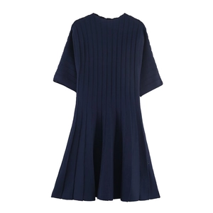 Detail of ribbed knit texture on navy blue midi dress with pleated A-line skirt